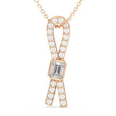 KATE LAB GROWN EMERALD CUT DIAMOND SET IN A STUDDED ELEGANT BOW PENDANT, GOLD